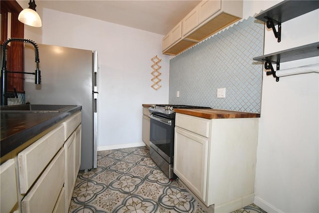 200 Graham St, Sewickley, PA 15143 - kitchen with electric range, baseboards, a sink, light tile patterned floors, and butcher block counters