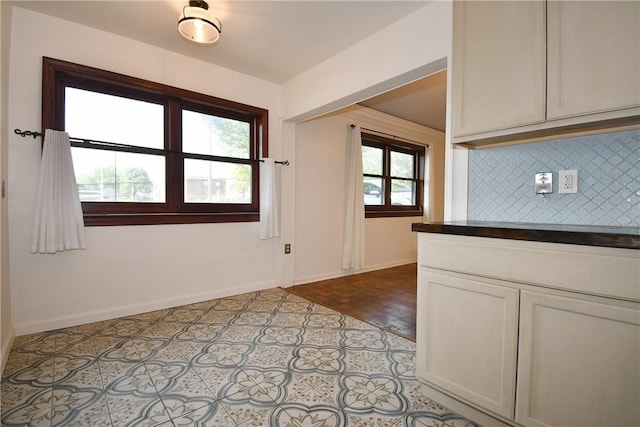 200 Graham St, Sewickley, PA 15143 - kitchen featuring backsplash, baseboards, dark countertops, and white cabinetry
