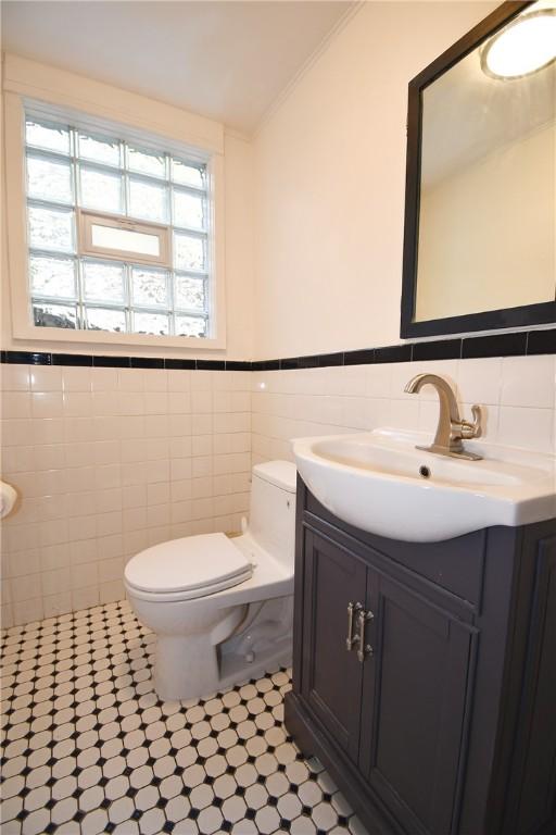 200 Graham St, Sewickley, PA 15143 - bathroom with tile walls, toilet, vanity, a wainscoted wall, and ornamental molding