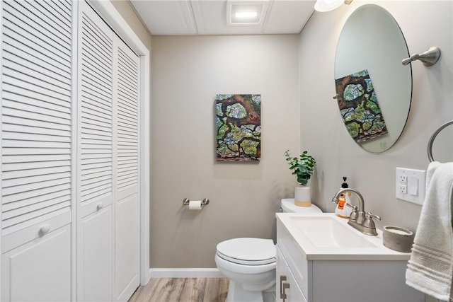 234 College Ave, Oakmont, PA 15139 - half bath with a closet, toilet, vanity, wood finished floors, and baseboards