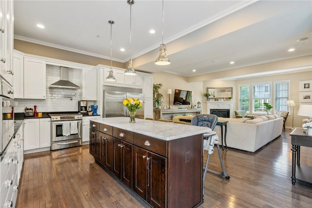 234 College Ave, Oakmont, PA 15139 - kitchen featuring stainless steel appliances, wall chimney range hood, dark brown cabinetry, white cabinetry, and crown molding