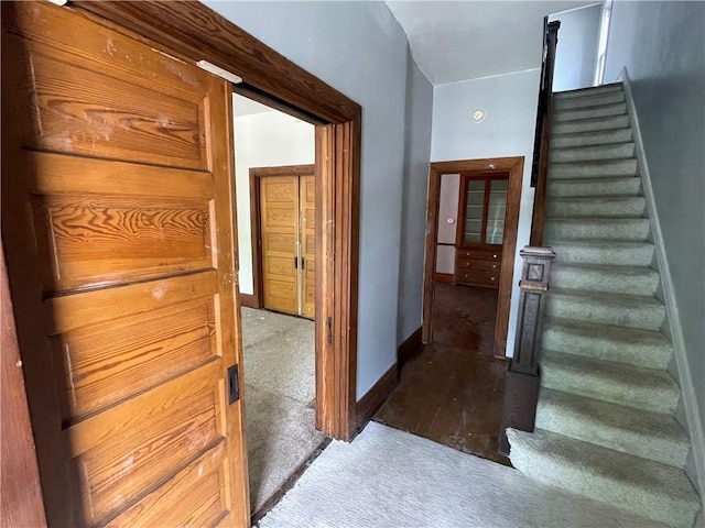 stairs featuring carpet floors and baseboards