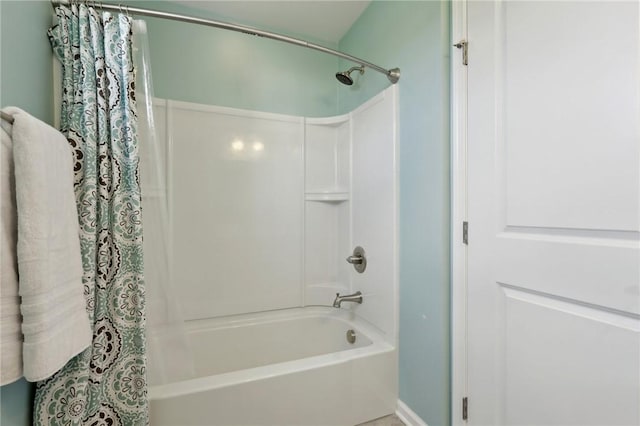 full bathroom featuring shower / bath combo with shower curtain and baseboards