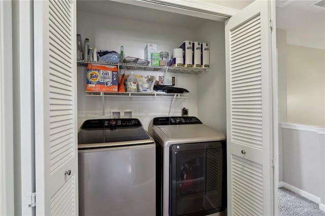 laundry area with independent washer and dryer, carpet flooring, and baseboards