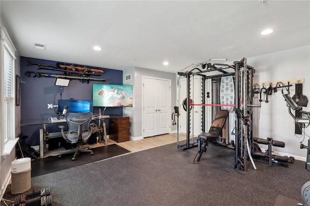exercise room featuring recessed lighting and baseboards
