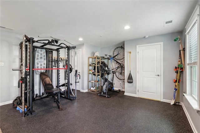 exercise room featuring baseboards and recessed lighting