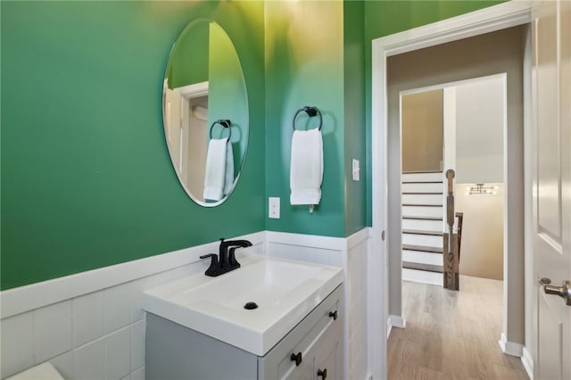 bathroom with wainscoting, vanity, and wood finished floors