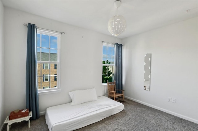 living area with healthy amount of natural light, carpet, and baseboards