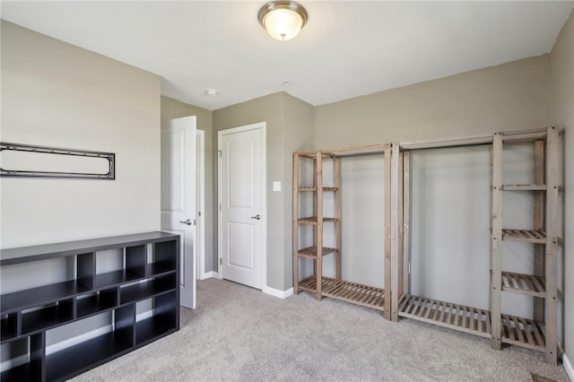 unfurnished bedroom featuring carpet and baseboards