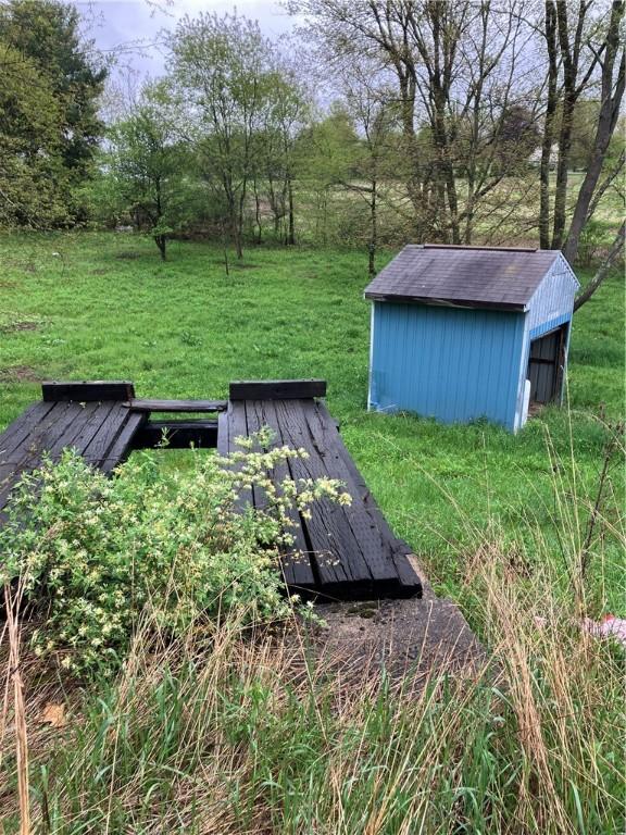 119 Reed Rd, Clearfield Twp, PA 16034 - entry to storm shelter with a yard and an outbuilding