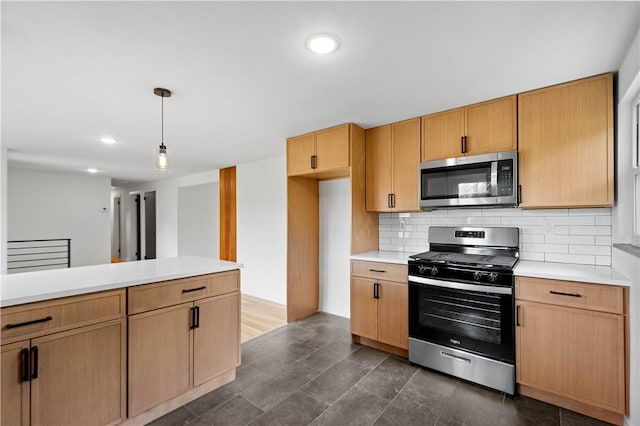 kitchen featuring stainless steel appliances, light countertops, decorative backsplash, decorative light fixtures, and recessed lighting