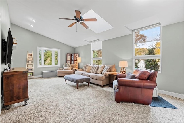 living room featuring a ceiling fan, carpet, baseboards, healthy amount of natural light, and lofted ceiling