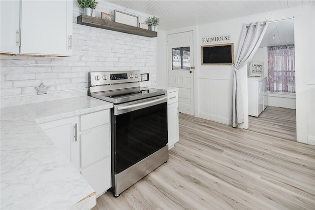 336 Walkchalk Rd, East Franklin Twp, PA 16201 - kitchen with stainless steel electric range, white cabinets, light wood-style floors, light stone counters, and open shelves