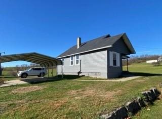 336 Walkchalk Rd, East Franklin Twp, PA 16201 - view of home's exterior featuring a yard, a carport, and a chimney