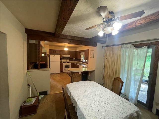 dining area with ceiling fan and beamed ceiling