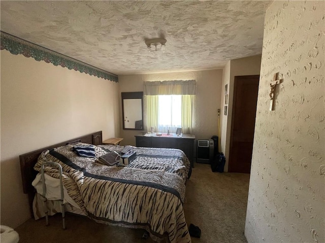 bedroom with a textured ceiling and carpet flooring