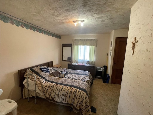 bedroom featuring a textured ceiling and carpet