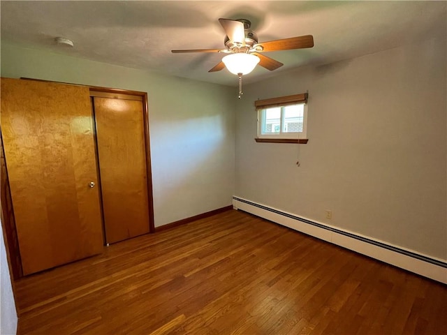 855 W Sanner St, Somerset Boro, PA 15501 - unfurnished bedroom featuring a baseboard heating unit, wood finished floors, a closet, baseboards, and a ceiling fan
