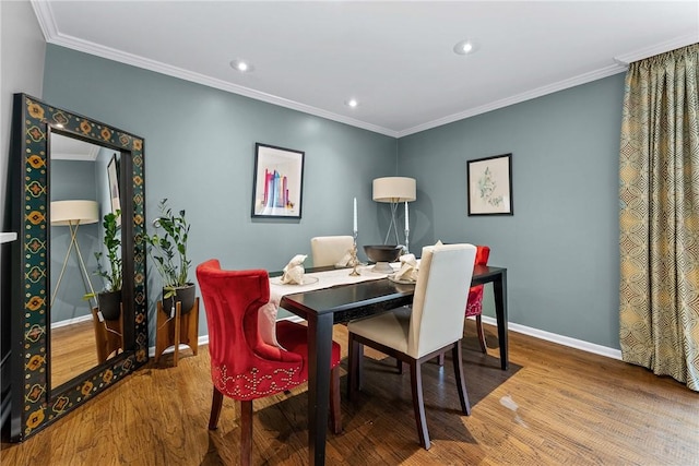 dining room featuring wood finished floors, baseboards, crown molding, and recessed lighting