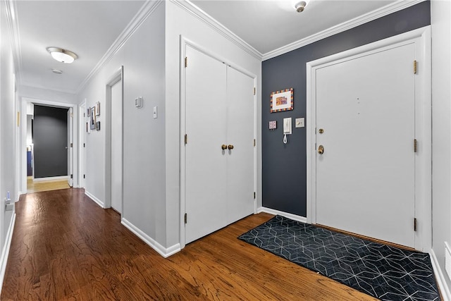 entrance foyer with wood finished floors, baseboards, and ornamental molding