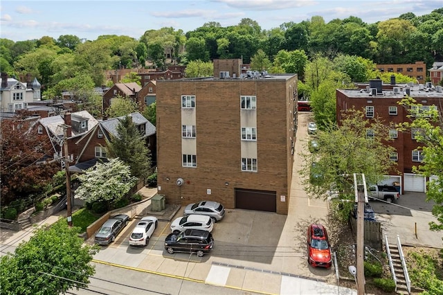 view of property with uncovered parking and an attached garage