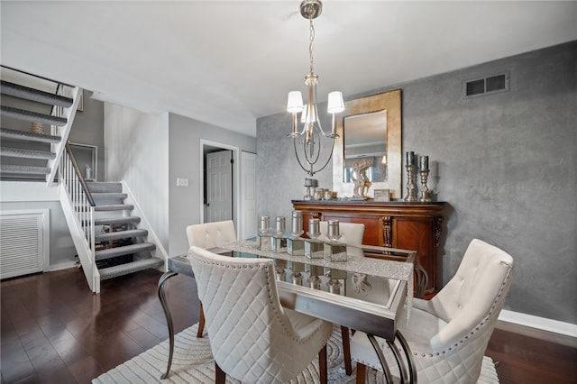 dining area with wood finished floors, stairs, a chandelier, and baseboards
