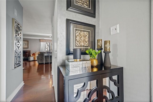 hall featuring wood finished floors and baseboards