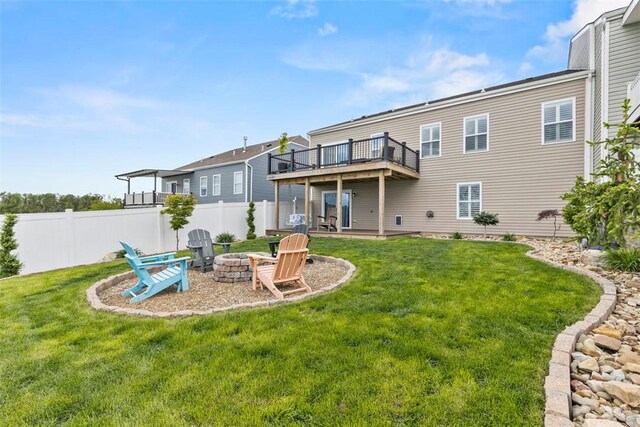 rear view of house featuring an outdoor fire pit