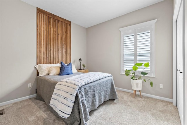 carpeted bedroom with baseboards