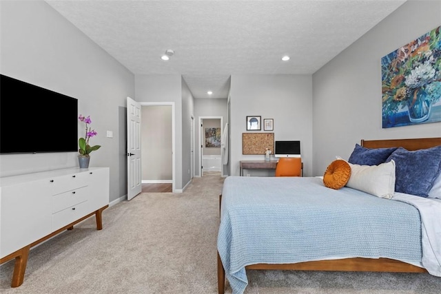 bedroom featuring light carpet, recessed lighting, baseboards, connected bathroom, and a textured ceiling