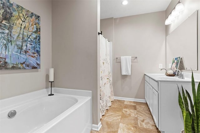 bathroom with a bath, vanity, recessed lighting, and baseboards