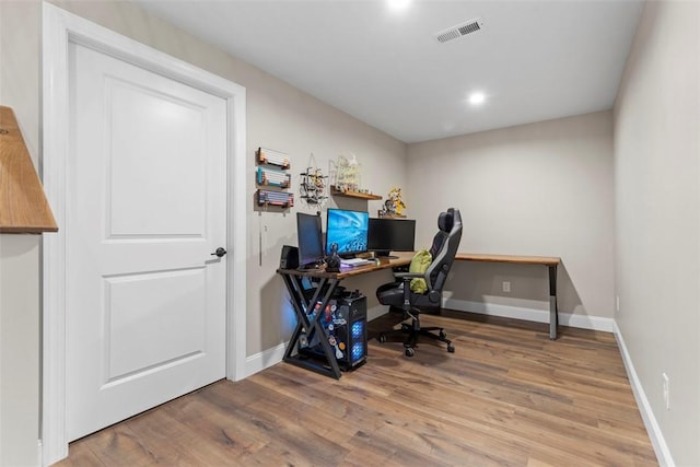 home office featuring wood finished floors, baseboards, and recessed lighting