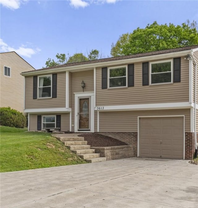 3613 Falmouth Dr, South Park, PA 15129 - bi-level home featuring an attached garage, driveway, a front lawn, and brick siding