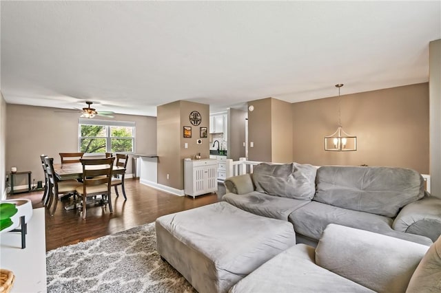 3613 Falmouth Dr, South Park, PA 15129 - living room featuring dark wood-style floors, ceiling fan, baseboards, and a chandelier