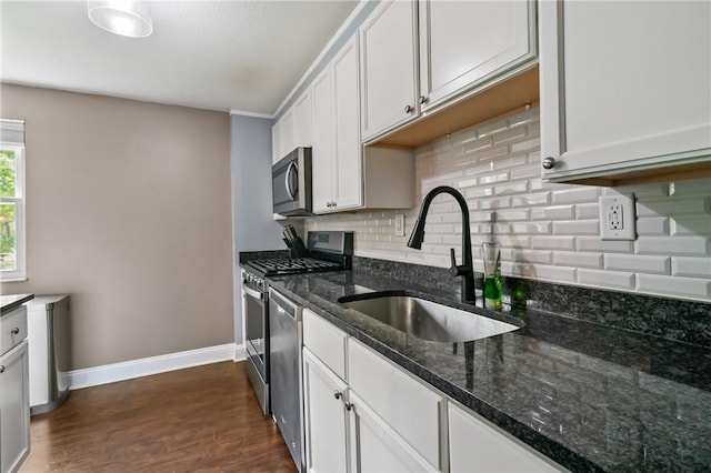 3613 Falmouth Dr, South Park, PA 15129 - kitchen featuring appliances with stainless steel finishes, a sink, baseboards, decorative backsplash, and dark wood-style floors