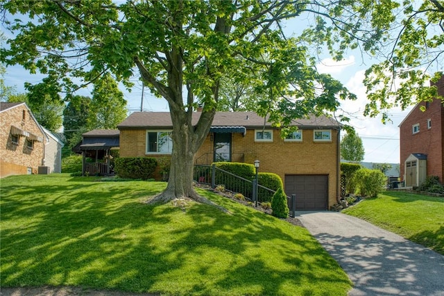 423 Nantucket Dr, Pleasant Hills, PA 15236 - view of front of property featuring asphalt driveway, an attached garage, brick siding, and a front yard