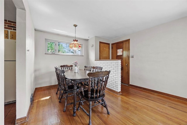 dining area with wood finished floors and baseboards