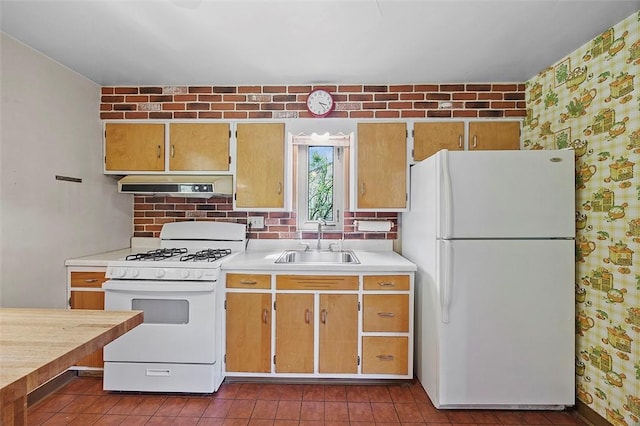 kitchen with white appliances, a sink, ventilation hood, light countertops, and wallpapered walls