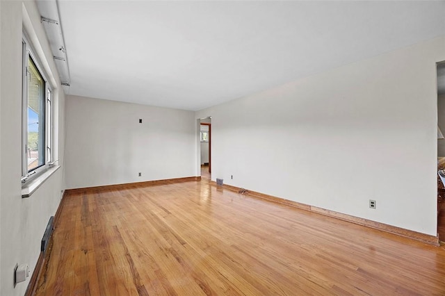 unfurnished room featuring light wood-type flooring and baseboards