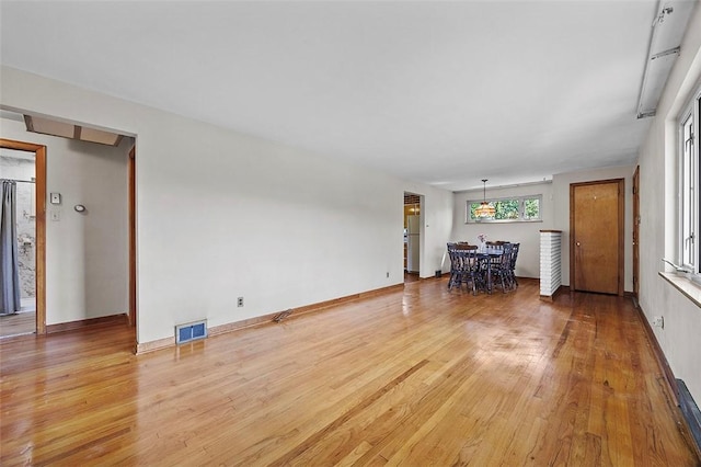 living room featuring light wood-style floors and baseboards