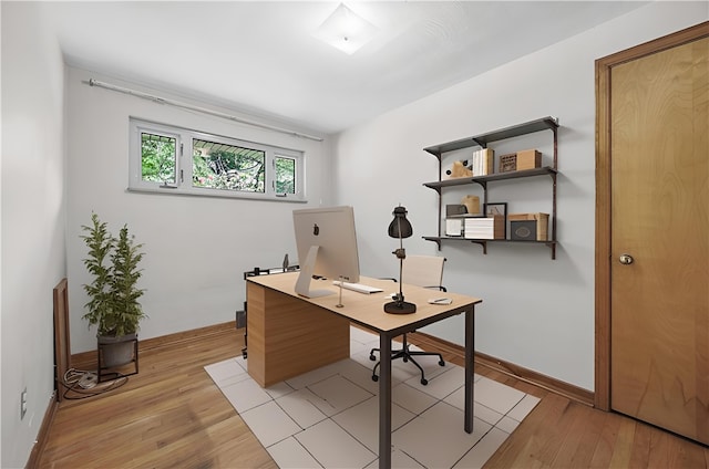 office space with light wood finished floors and baseboards