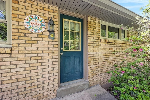 entrance to property with brick siding