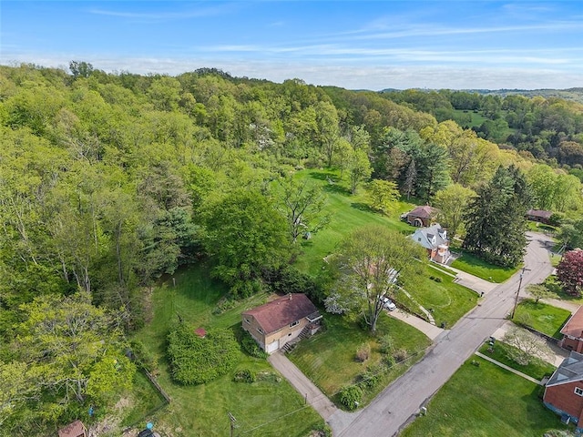view of property location featuring a forest