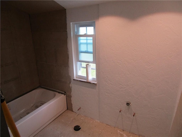 bathroom featuring a textured wall