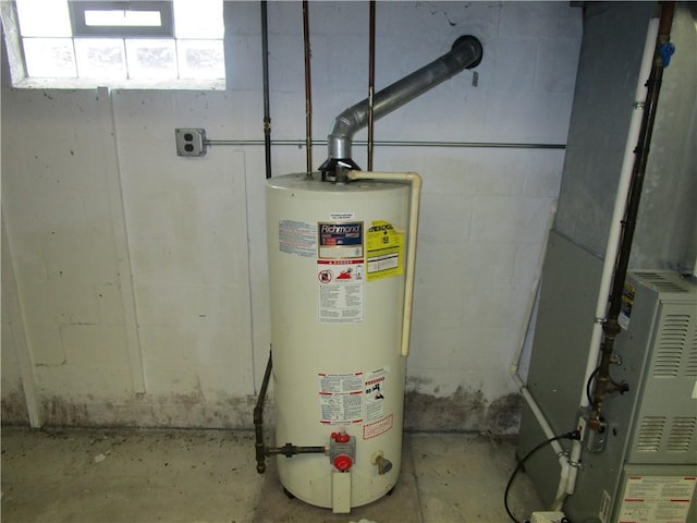 utility room featuring water heater and heating unit