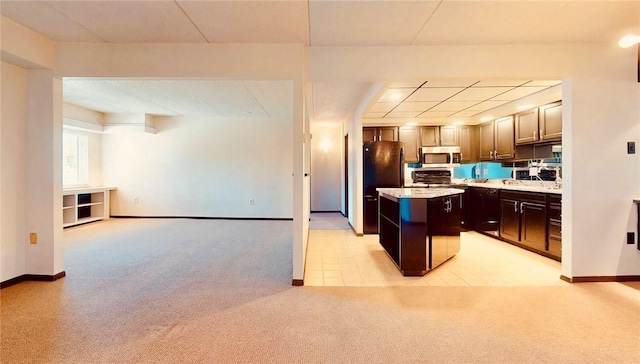 5600 Munhall Rd Unit 403, Squirrel Hill, PA 15217 - kitchen with stainless steel microwave, light colored carpet, a center island, freestanding refrigerator, and baseboards