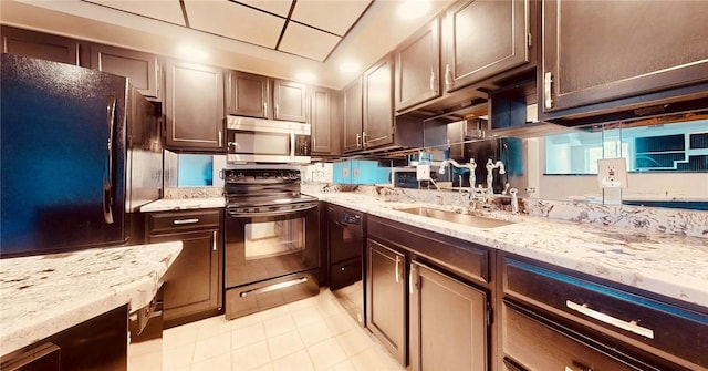 5600 Munhall Rd Unit 403, Squirrel Hill, PA 15217 - kitchen featuring black appliances, a sink, light stone countertops, dark brown cabinetry, and light tile patterned floors