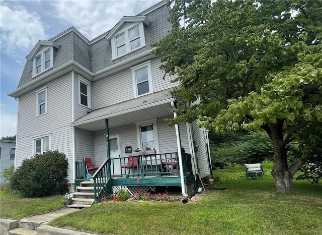 835 6th Ave, Brackenridge, PA 15014 - victorian home featuring mansard roof, covered porch, a front lawn, and a shingled roof