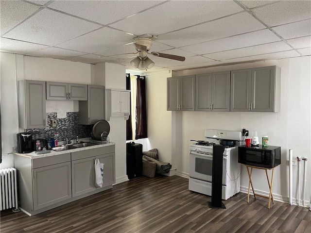 835 6th Ave, Brackenridge, PA 15014 - kitchen featuring gas range gas stove, gray cabinets, black microwave, radiator heating unit, and dark wood finished floors