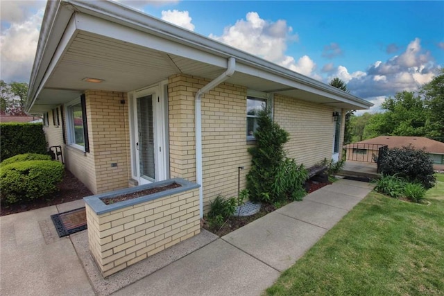 view of property exterior with brick siding